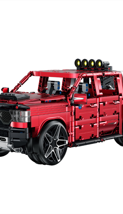 A 1,349-piece 1:14 electroplated-red off-road pickup with roof spotlights, openable doors and tailgate. Static display, RC-upgradeable for 360° drift & mist. 